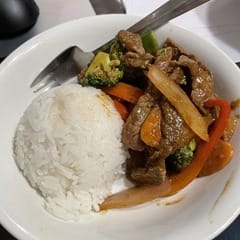 White bowl containing a mound of white rice and Hoisin Beef Stir-fry